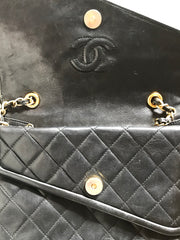 Vintage CHANEL black leather double envelop style flap shoulder bag with chain strap and fringe.