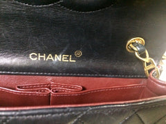 Vintage CHANEL black lambskin mini shoulder bag, classic 2.55 purse with gold tone CC closure.
