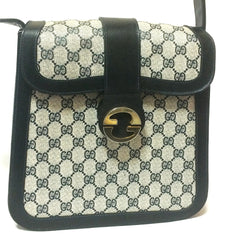 Vintage Gucci navy monogram postman shoulder purse with golden GG closure and adjustable shoulder stap. Unisex bag