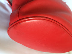 Vintage Paloma Picasso red leather hobo bucket style shoulder bag with golden logo motifs.