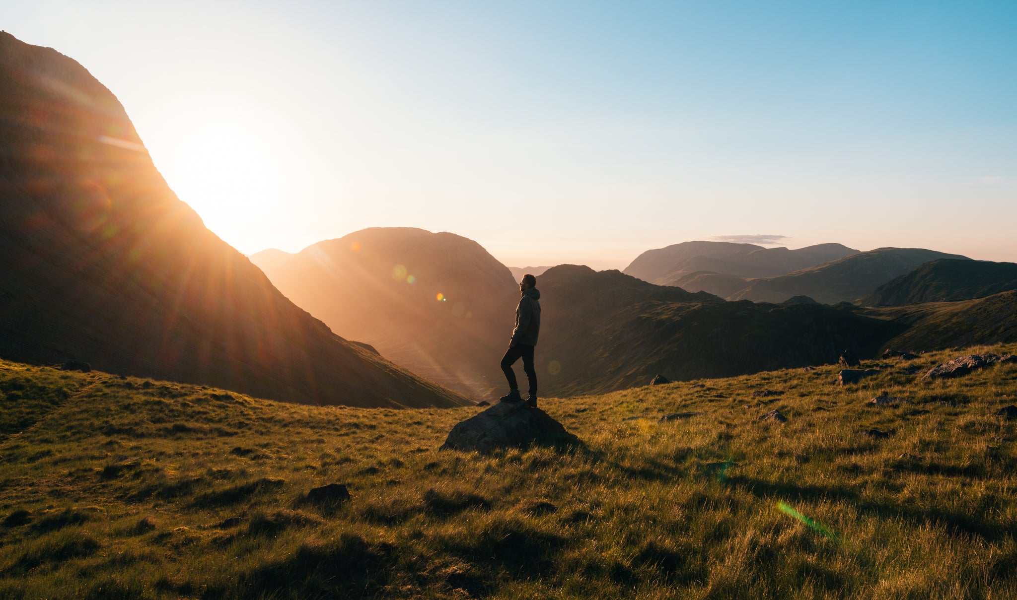 photographing silhouette of a man on a mountain at sunrise