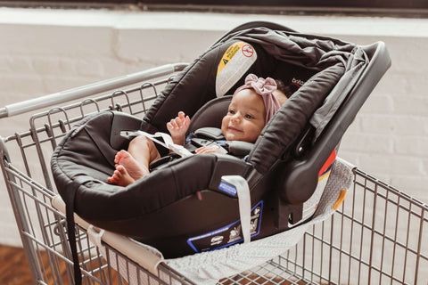 baby in shopping cart in car seat using binxy baby hammock