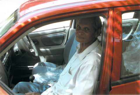 Rev. Benjamin next to his new car that our ministry bought him. He travels to villages with it, preaching the gospel.