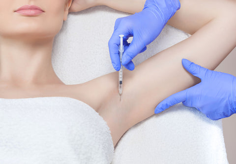 Woman receiving botox in her armpit for hyperhidrosis