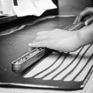 Hand-cut logo stamp for Hill & Ellis bags at Le Velo Victoria