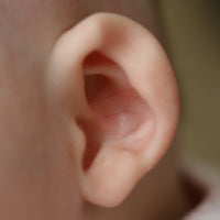 baby with a ear that folds at the rim | ear buddies