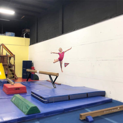 Eva leaping off a balance beam