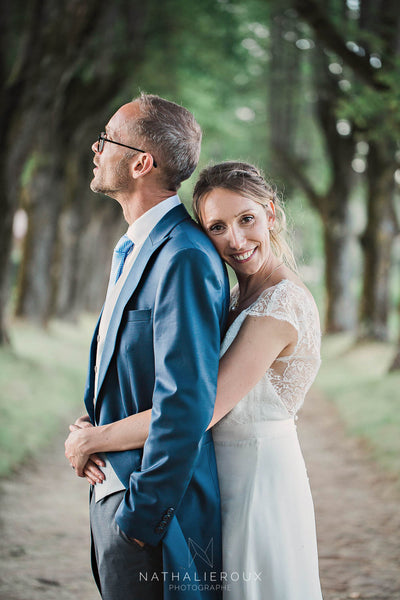 Happy couple with bride wearing a custom peony rice silk wedding dress