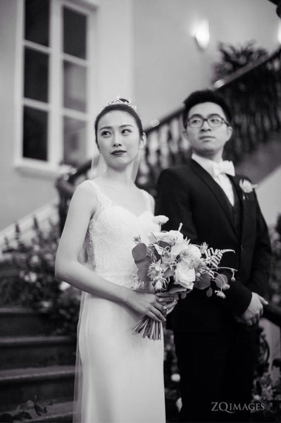 Peony Rice bride and groom walking down the stairs