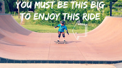 Child on skateboard ramp - you must be this big to enjoy this ride