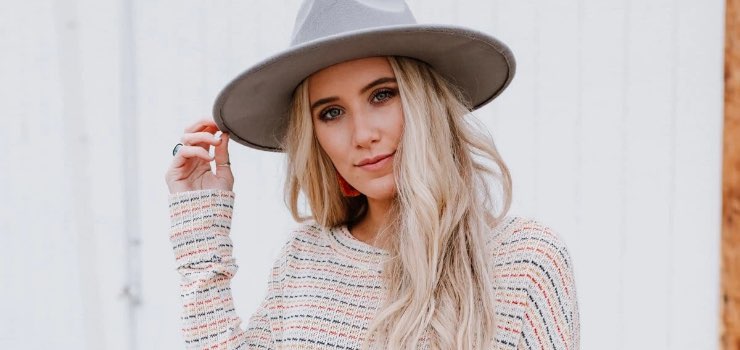 model wearing a gray Venice wide brim hat with a teal lace tank top