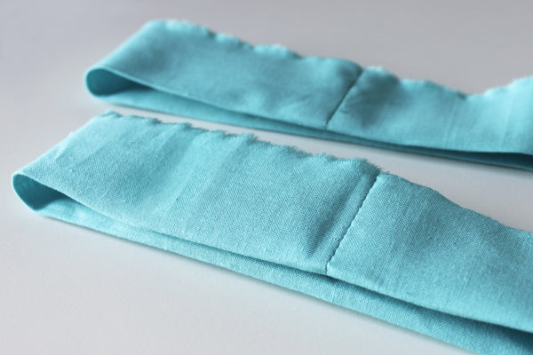 Fold along the middle with wrong sides facing