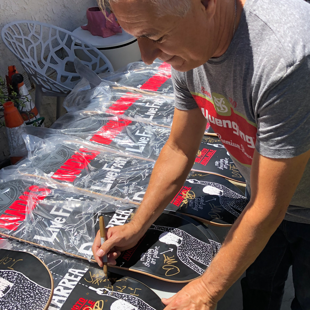 Joe Escalante signing the Vandals "Live Fast, Diarrhea" skateboard decks