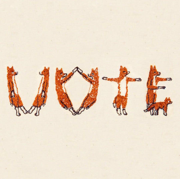 embroidered foxes spelling out Vote!