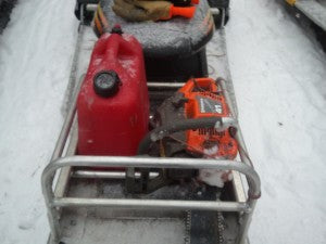 Chainsaw loaded in sled rack