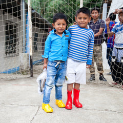 roma foundation guatemala boys in colorful rain boots