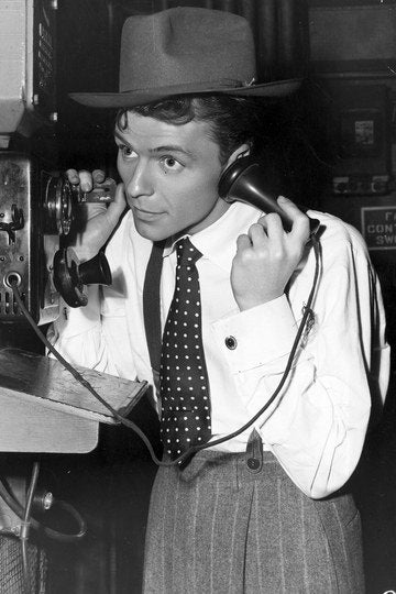 Frank Sinatra, posing at phone