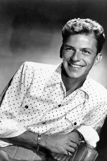 Frank Sinatra, posing in studio wearing a white shirt with black polka dots