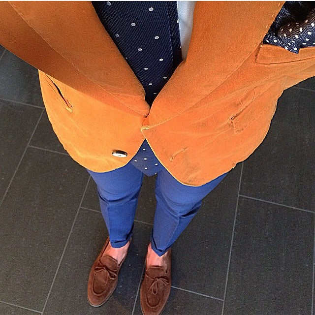 Keyman Style wearing orange suit and blue necktie