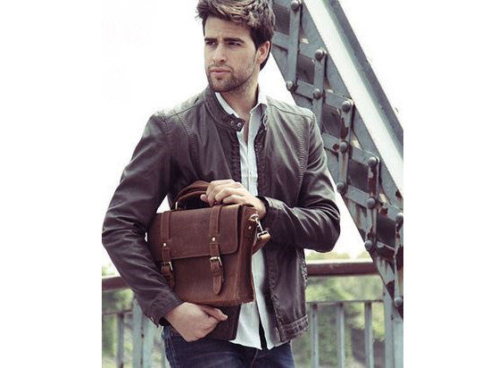 Stylish man sporting a signature brown leather messenger bag by SerBags