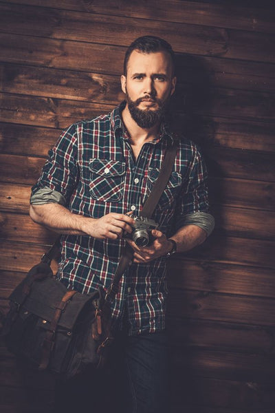 sexy man sporting an elegant mens messenger bag by Serbags