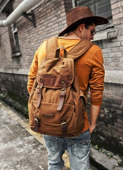 Stylish man sporting the brown canvas and leather rucksack by Serbags