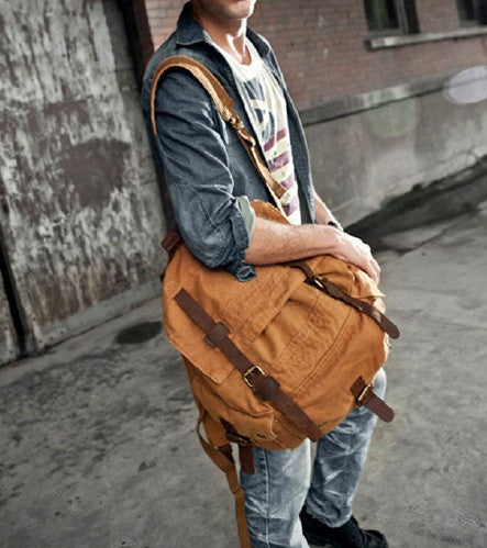 Man wearing the brown canvas travel backpack by Serbags