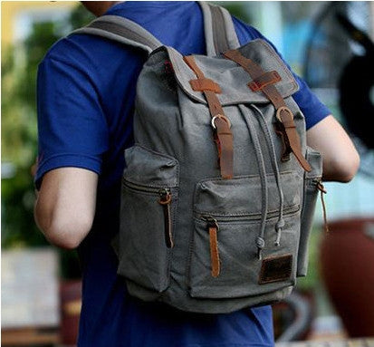 Man wearing the Serbags gray casual canvas backpack with laptop compartment