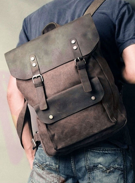 Man wearing the dark brown vintage casual canvas leather student backpack