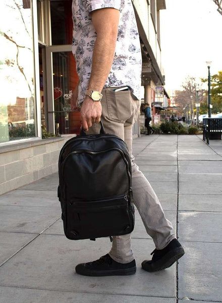Man wearing casual attire & black classic leather backpack 2