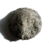 Top view of a gray, handfelted beret after it has been hand washed.