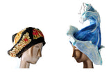 Two previous Custom Order Hats: a gold, black, red and blue Beret inspired by Gustav Klimt's 'The Kiss' and a sculptural wave-shaped hat inspired by the ocean.