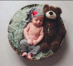 Little Heart Warrior and a Mended Heart Bummer Bear cozy in a basket together.