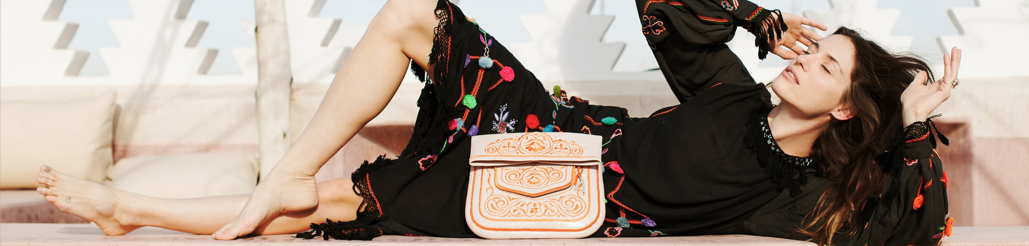 model lying on Marrakech rooftop with ABURY Berber Bag