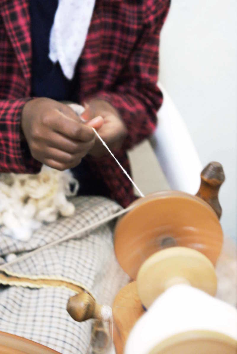 picture of someone spinning the silk to make it a fiber