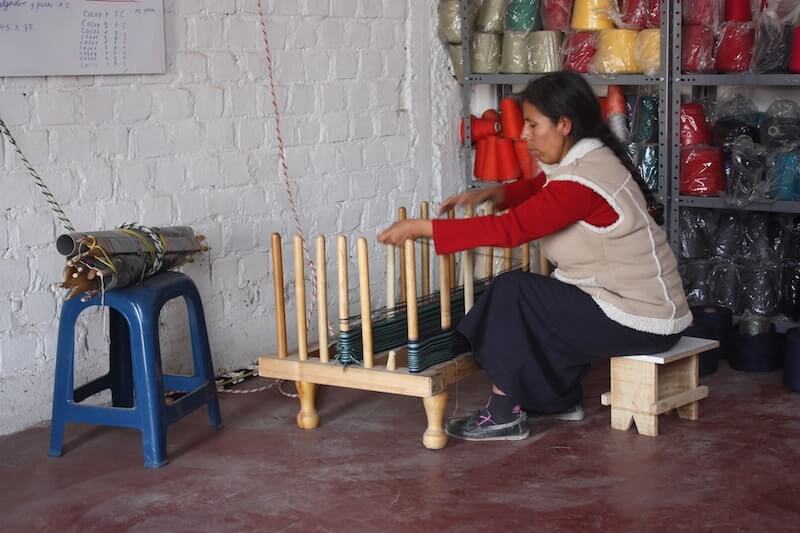 peruvian woman artisan working on a piece