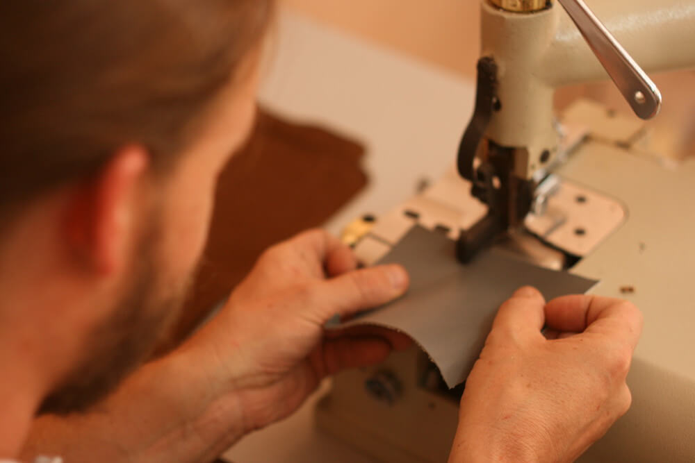 close up of the designer working on a bag