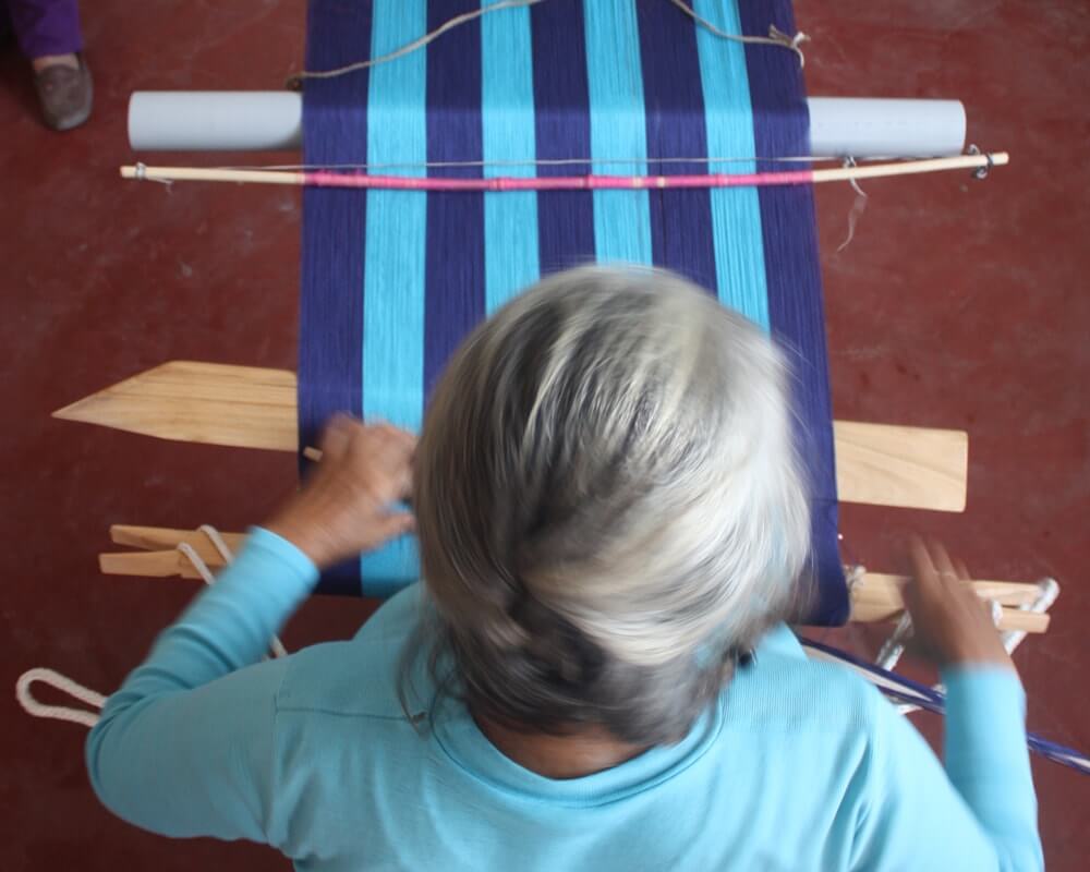 close up of a woman weaving in peru