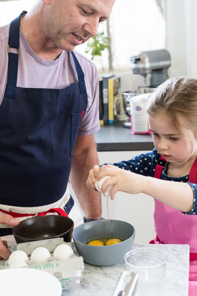 Eloise breaks some eggs with her dad, Chef Cyrille Pannier 