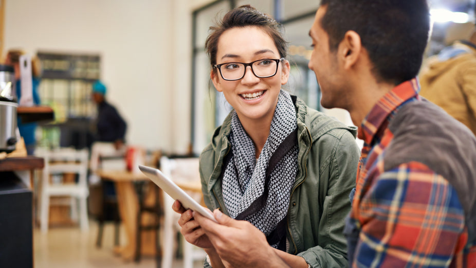 woman and man talking with an ipad