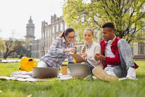 Group-of-college-students-studying-outside