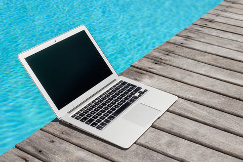 MacBook-Air-on-the-deck-by-a-pool