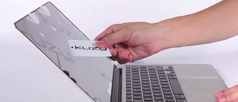 Use-a-hard-card-to-remove-dust-bubbles-on-MacBook-from-a-screen-protector