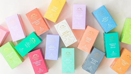 Colorful boxes of Sloane tea against a white background.