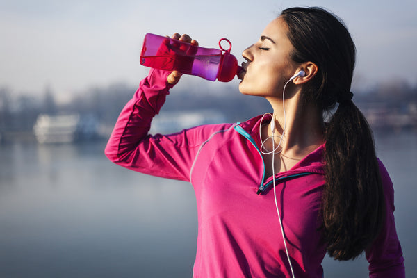 woman drinking water to stay hydrated