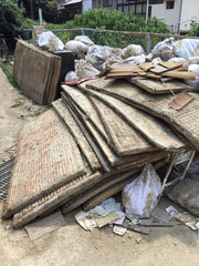 pile of ruined tatami straw mats after flood