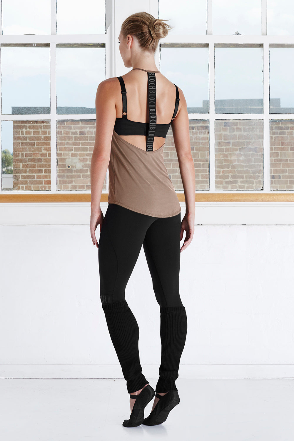 A female dancer in the studio wearing BLOCH leggings and a T back top