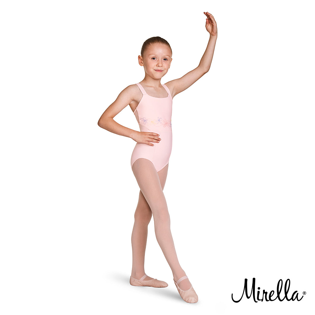 A young ballet dancer dancing wearing the Mirella open back camisole leotard in pink