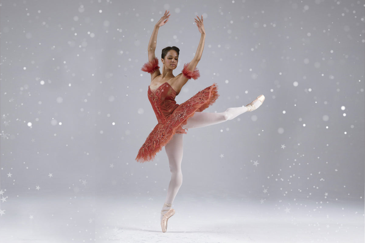 Ballerina Misty Copeland dancing en pointe wearing Nutcracker Christmas performance costume and pointe shoes