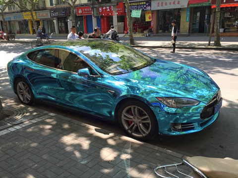 Tesla Model S wrapped in crystal blue ocean water